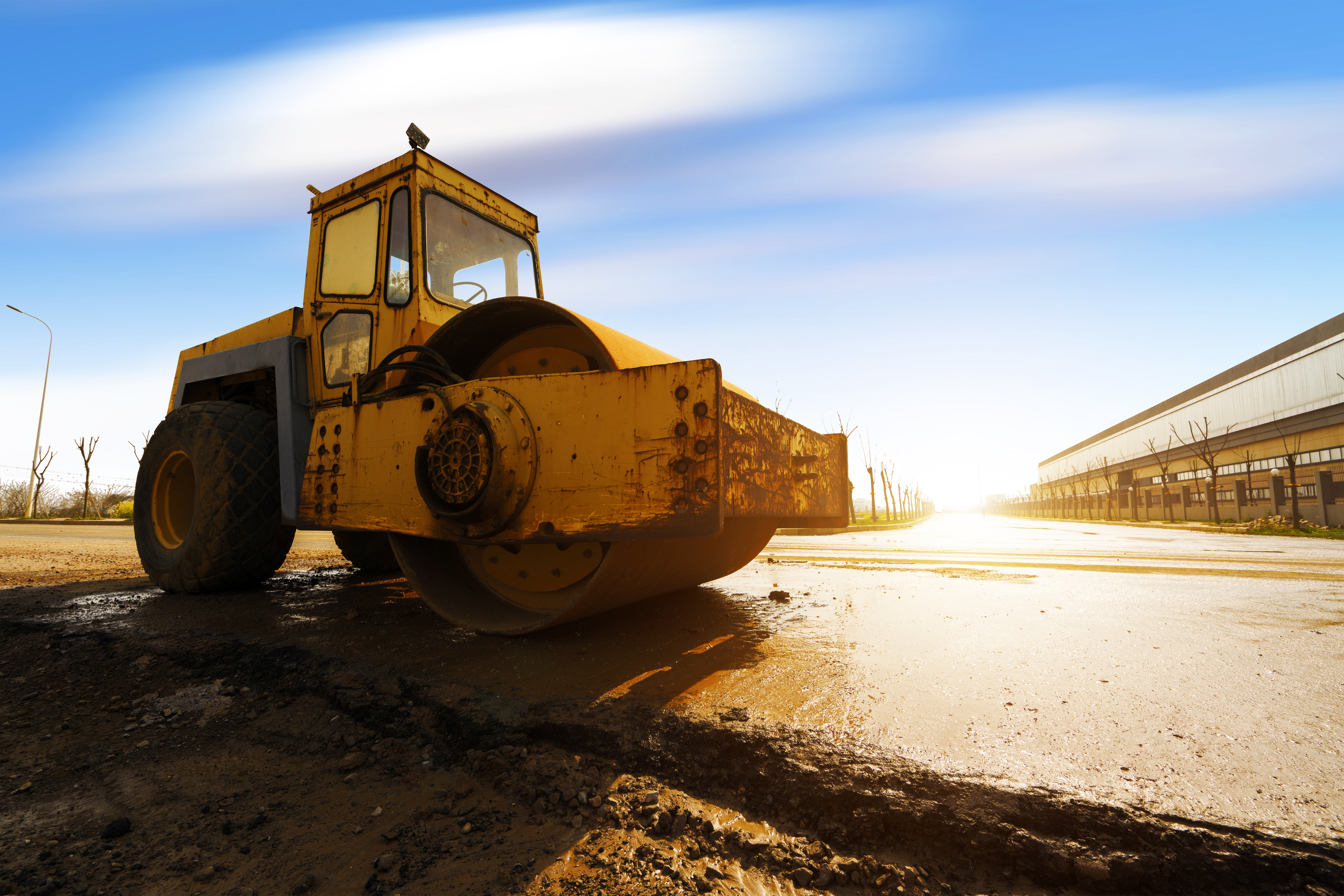 Vibratory soil compactor working on highway construction site